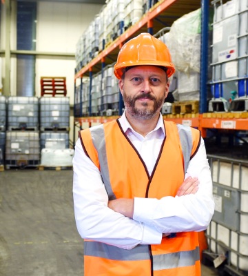 Man wearing hard hat stood in warehouse