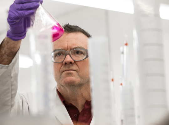 Scientist looking at a test tube